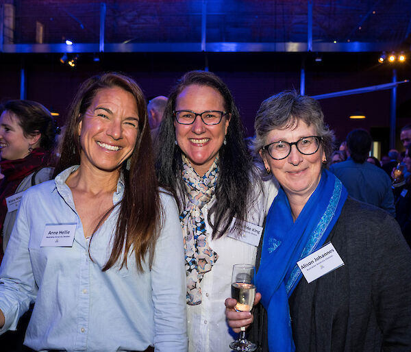 three women smiling at the camera