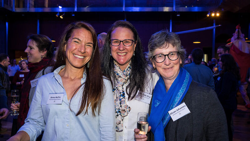 three women smiling at the camera