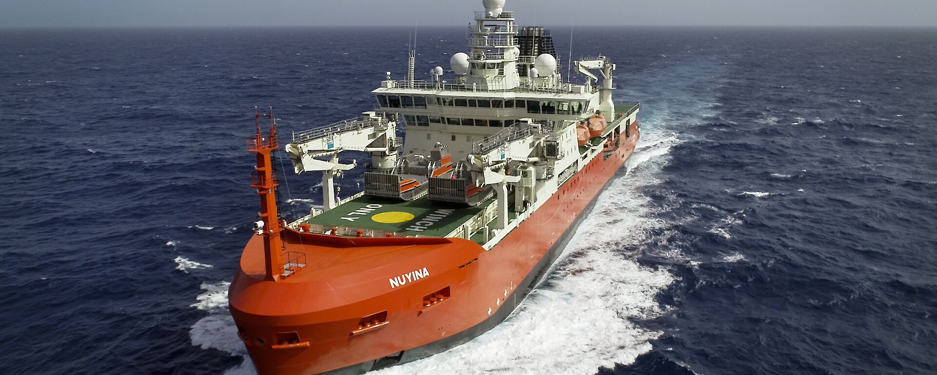 red icebreaker moving through the ocean