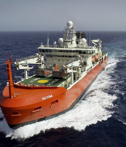 red icebreaker moving through the ocean