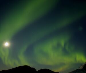 A green aurora floating across the night sky.