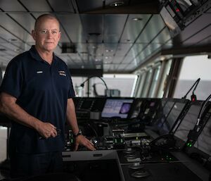 Captain of the ship stands at the helm