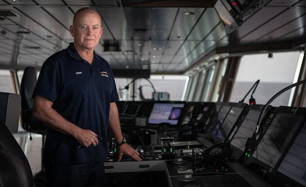 Captain of the ship stands at the helm