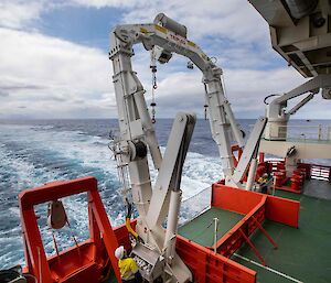 A white A-frame for deploying nets and other equipment from the trawl deck