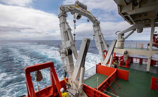 A white A-frame for deploying nets and other equipment from the trawl deck