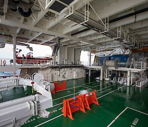 The trawl deck showing A-frame, winch systems, net drums, cranes and one of the personnel tenders