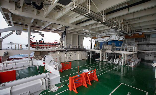 The trawl deck showing A-frame, winch systems, net drums, cranes and one of the personnel tenders