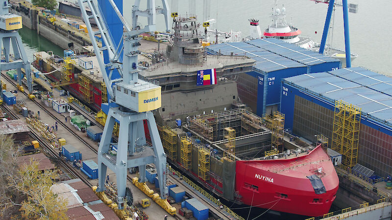 Ship in dry dock undergoing construction.