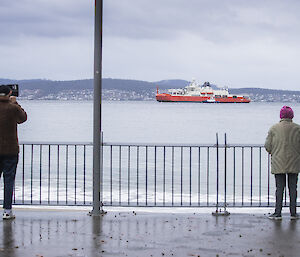 People watching the RSV Nuyina sail up the Derwent in Hobart