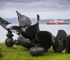 Statue in foreground; RSV Nuyina in background