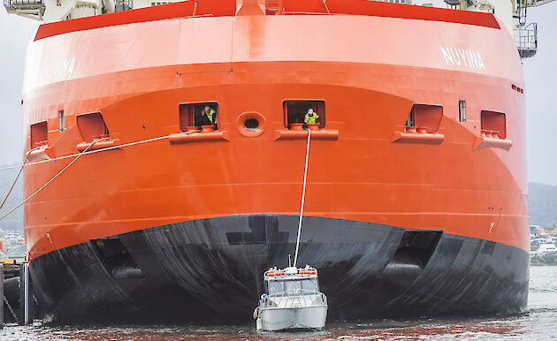 RSV Nuyina being pulled by tug