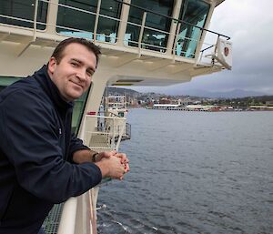 Crew member looking off the deck of the RSV Nuyina