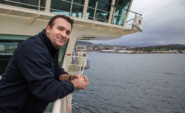 Crew member looking off the deck of the RSV Nuyina