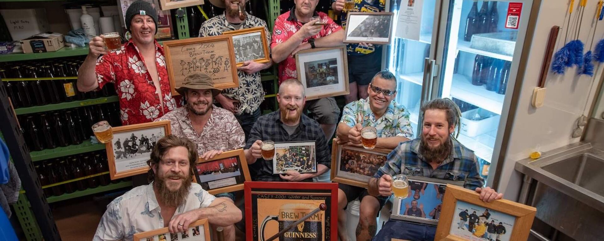 A group of people in Hawaiian shirts holding memorabilia and a glass of beer each