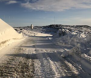 A newly groomed station road with snow piles on either side