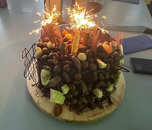 Decorated chocolate cake with sparklers.