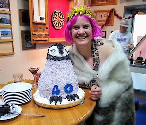 Birthday cake in the shape of a fluffy emperor penguin chick.