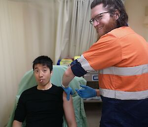 An expeditioner getting an injection
