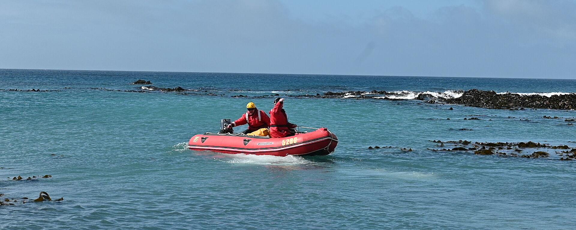 A red dinghy out on the water