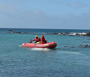A red dinghy out on the water