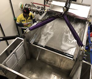 Aerial view of the prototype filter and collection tank, with a stream of water washing across a mesh screen into the tank.