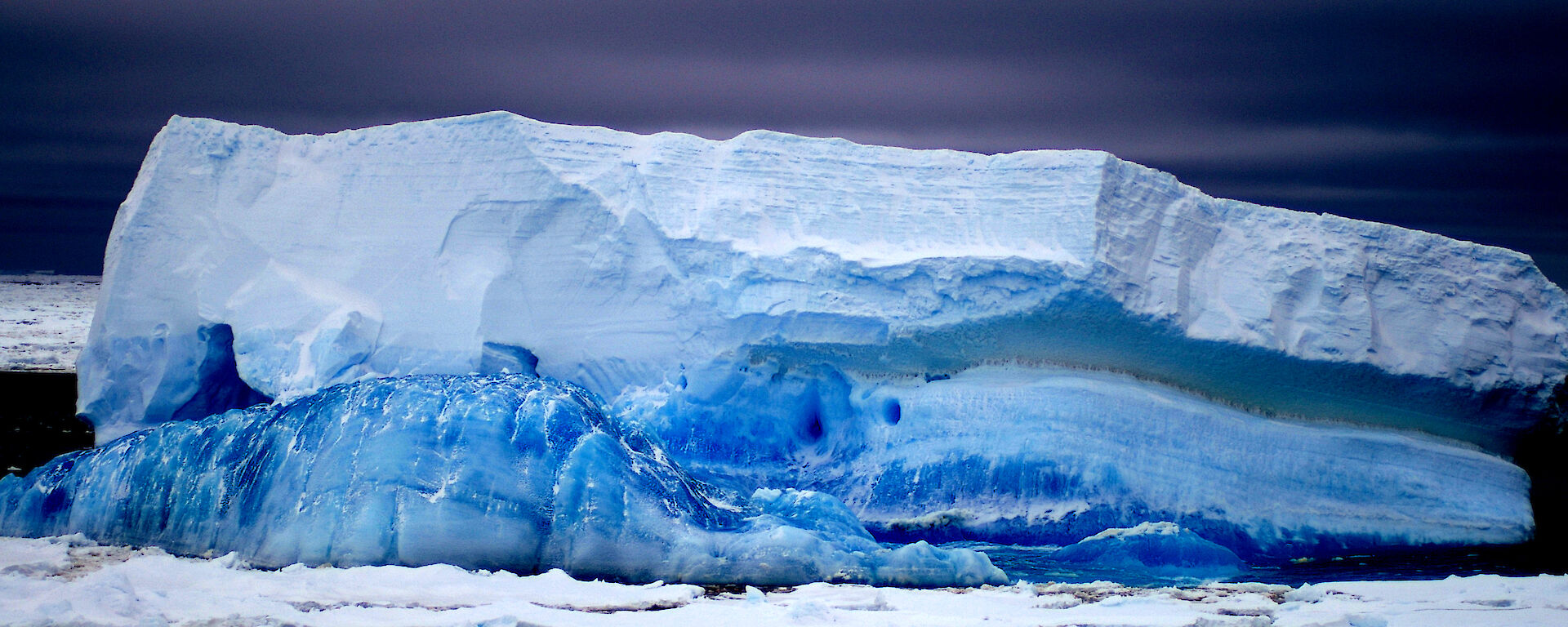 Strata layers of blue ice on tabular iceberg