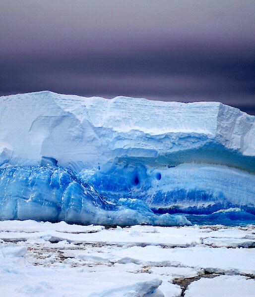 Strata layers of blue ice on tabular iceberg