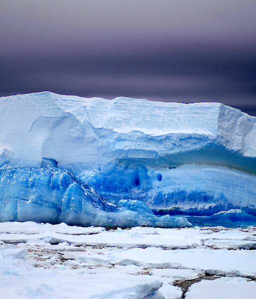 Strata layers of blue ice on tabular iceberg