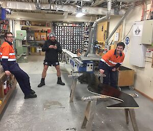 3 men in a workshop making the giant moustache