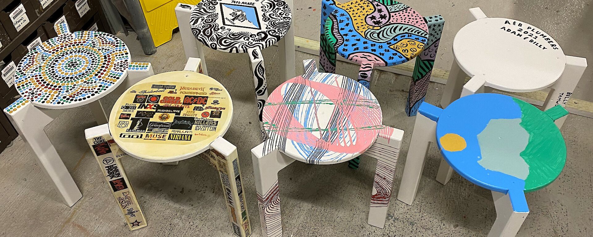 Seven individually painted stools looking colourful and fun