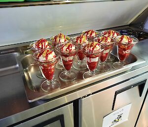 Dessert glasses are filled with a delicious looking sweets