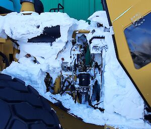 The engine of a vehicle at Mawson caked in snow after a blizzard