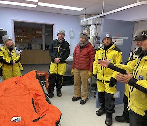 A group of expeditioners standing in the medical facility