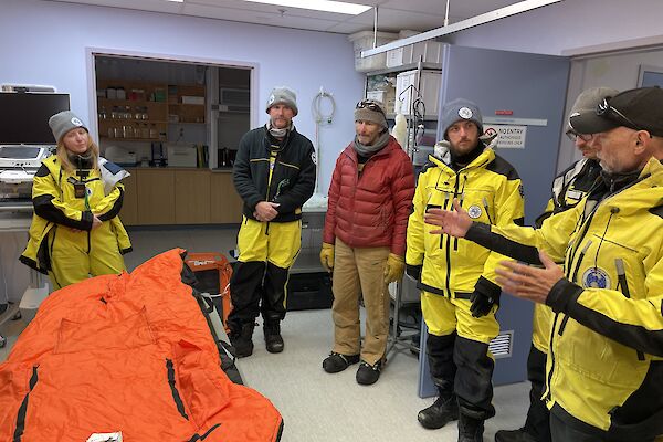 A group of expeditioners standing in the medical facility