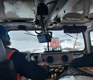 The view from the back seat of a Hägglunds, 2 people in the front seat