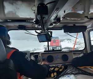 The view from the back seat of a Hägglunds, 2 people in the front seat