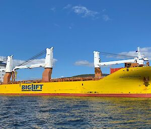 yellow cargo ship in river