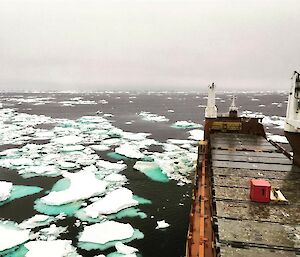 deck of cargo ship surrounded by ice