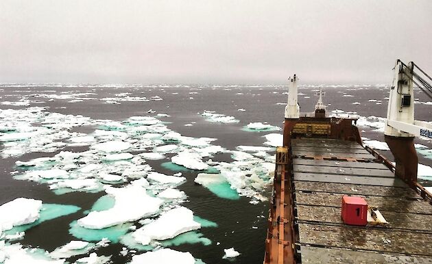 deck of cargo ship surrounded by ice