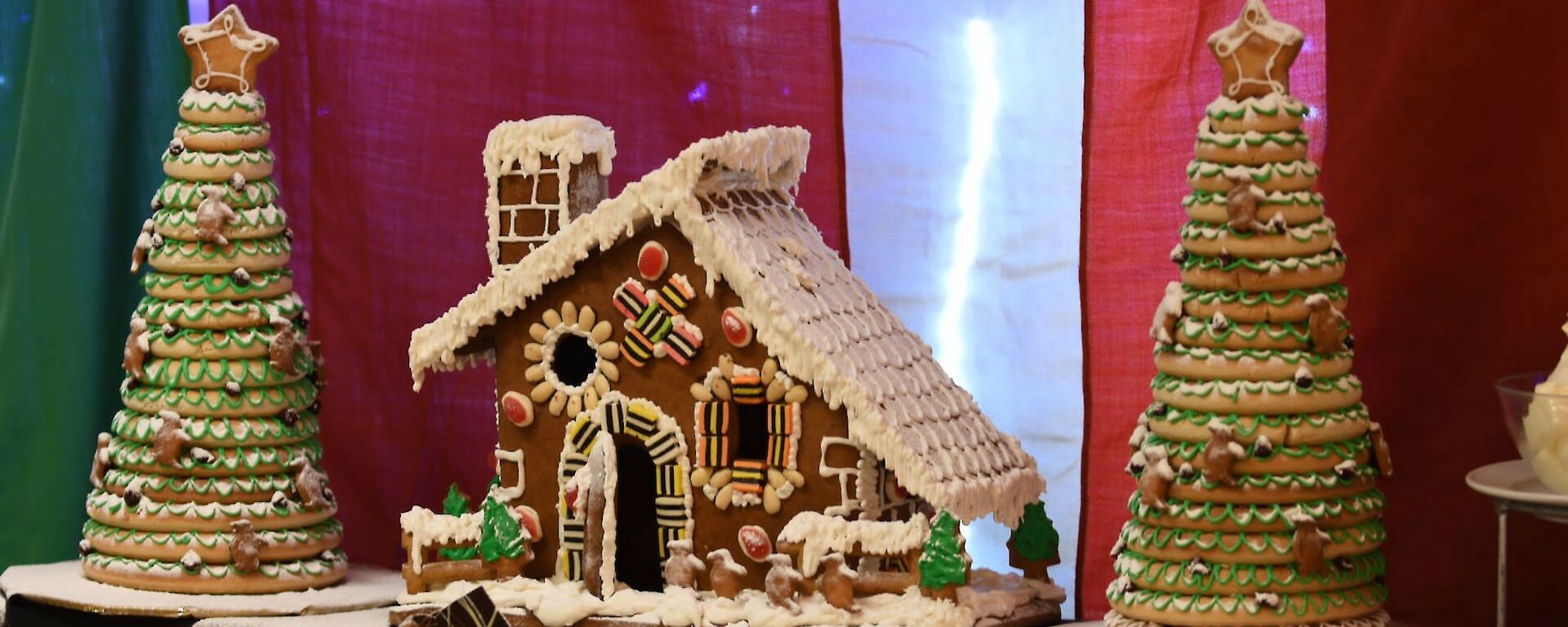 Gingerbread house complete with large gingerbread trees