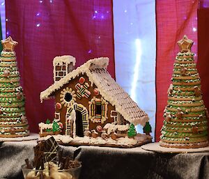 Gingerbread house complete with large gingerbread trees