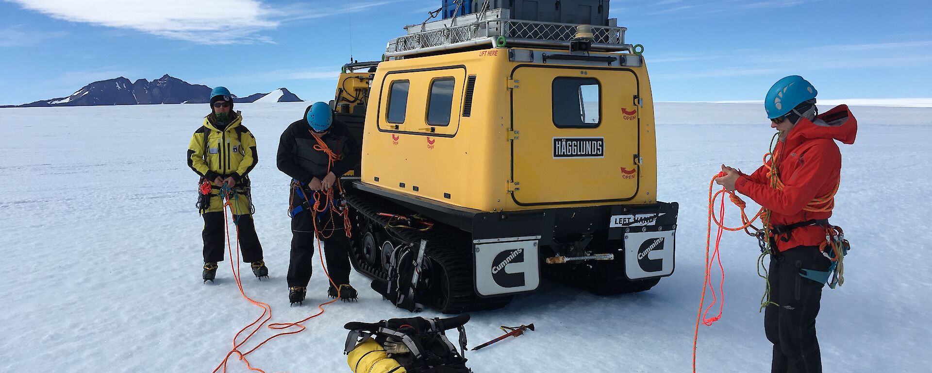 Expeditioners rope up together near the Hagglunds before heading into crevassed terrain