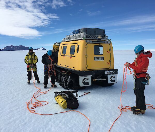 Expeditioners rope up together near the Hagglunds before heading into crevassed terrain