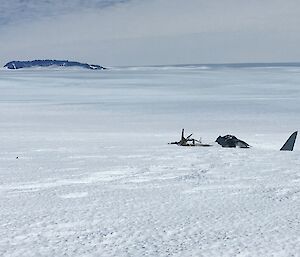 The Russian aircraft wreck with the Casey Range in the background on the ice plateau near Mawson station