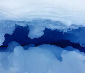 Deep blue with oddly shaped ice sides - looking down into one of the many crevasses on the ice plateau above Mawson station