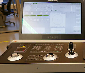 View of console with controls, keyboard and joystick.