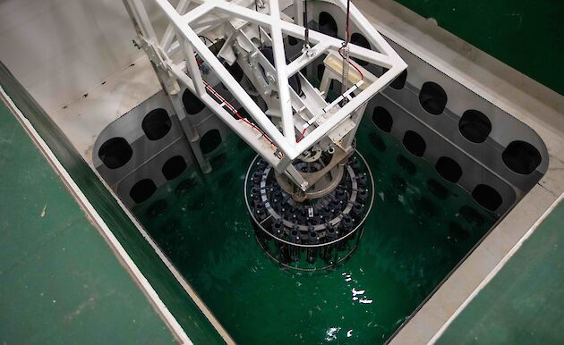 equipment lowered into pool of water