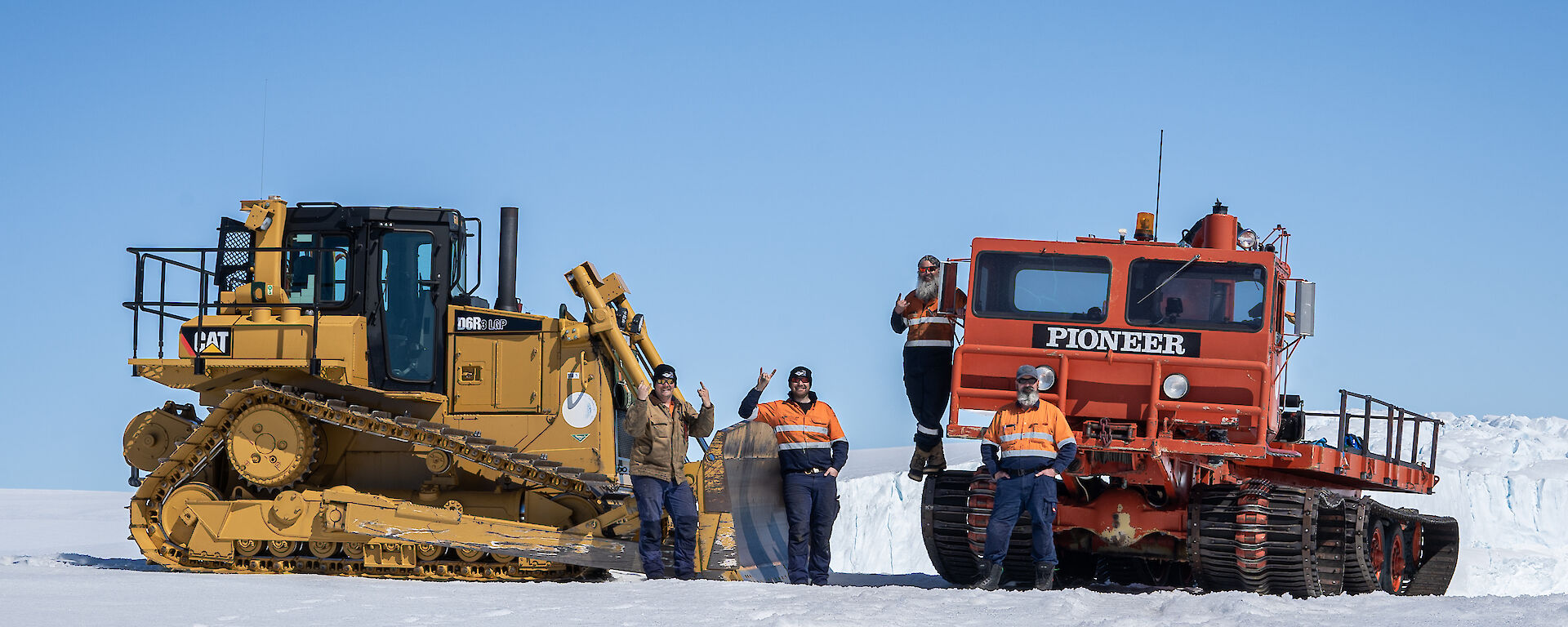The Mawson D6 bulldozer and old but still impressive Pioneer on a snow hill to the west of station with SMS Dane Eden, SSO Simon White, Diesel mechanics David Kolfen and Boilermaker Welder Chris Bayly