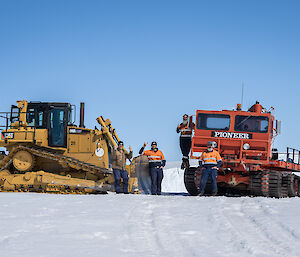 The Mawson D6 bulldozer and old but still impressive Pioneer on a snow hill to the west of station with SMS Dane Eden, SSO Simon White, Diesel mechanics David Kolfen and Boilermaker Welder Chris Bayly