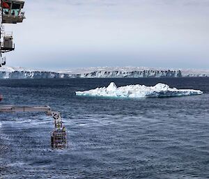 equipment lowered from side of ship into icy water